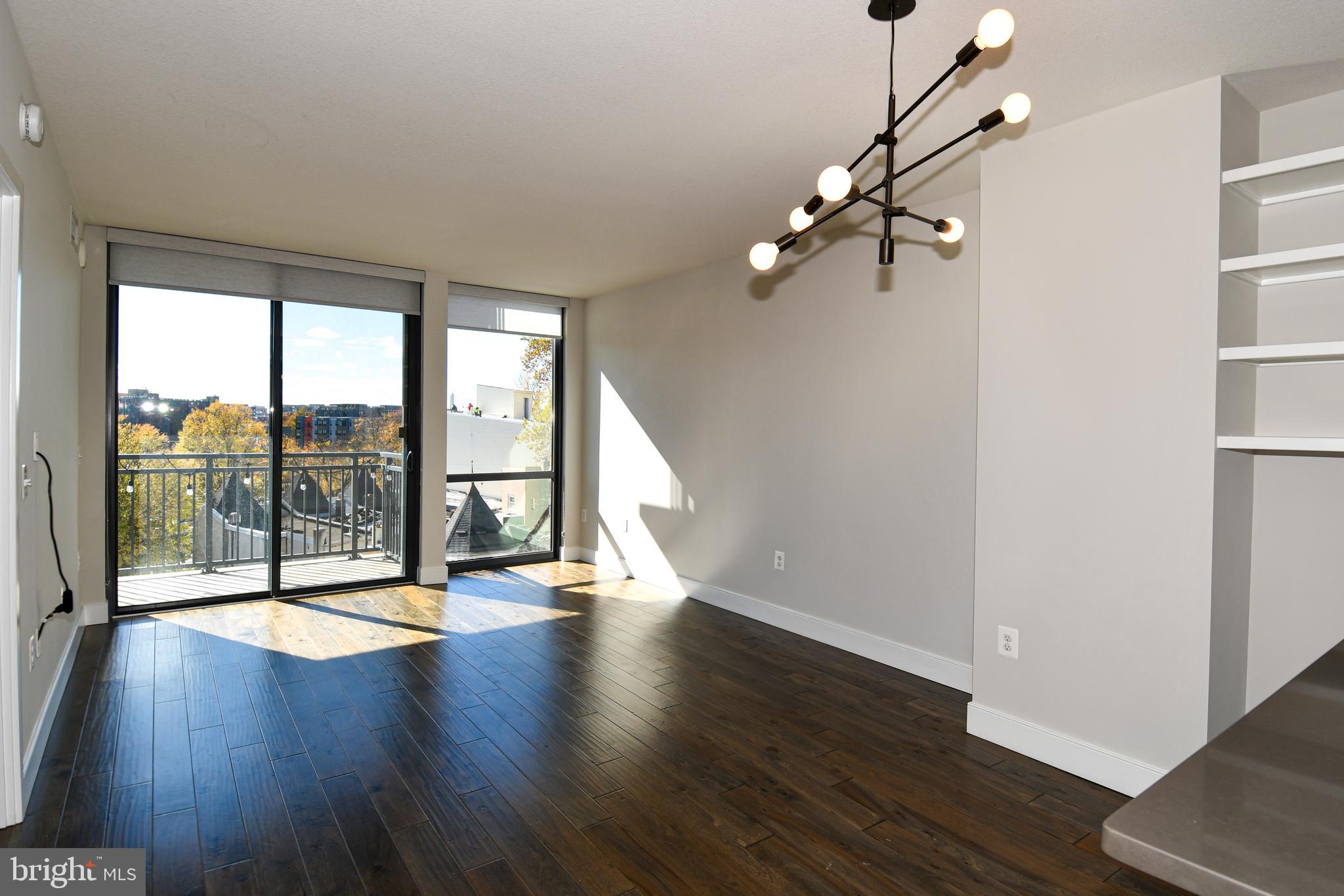 50 Florida Avenue Northeast, Unit 523 Washington, DC 20002 - Photo 5 of 38 a view of an empty room with wooden floor and a window