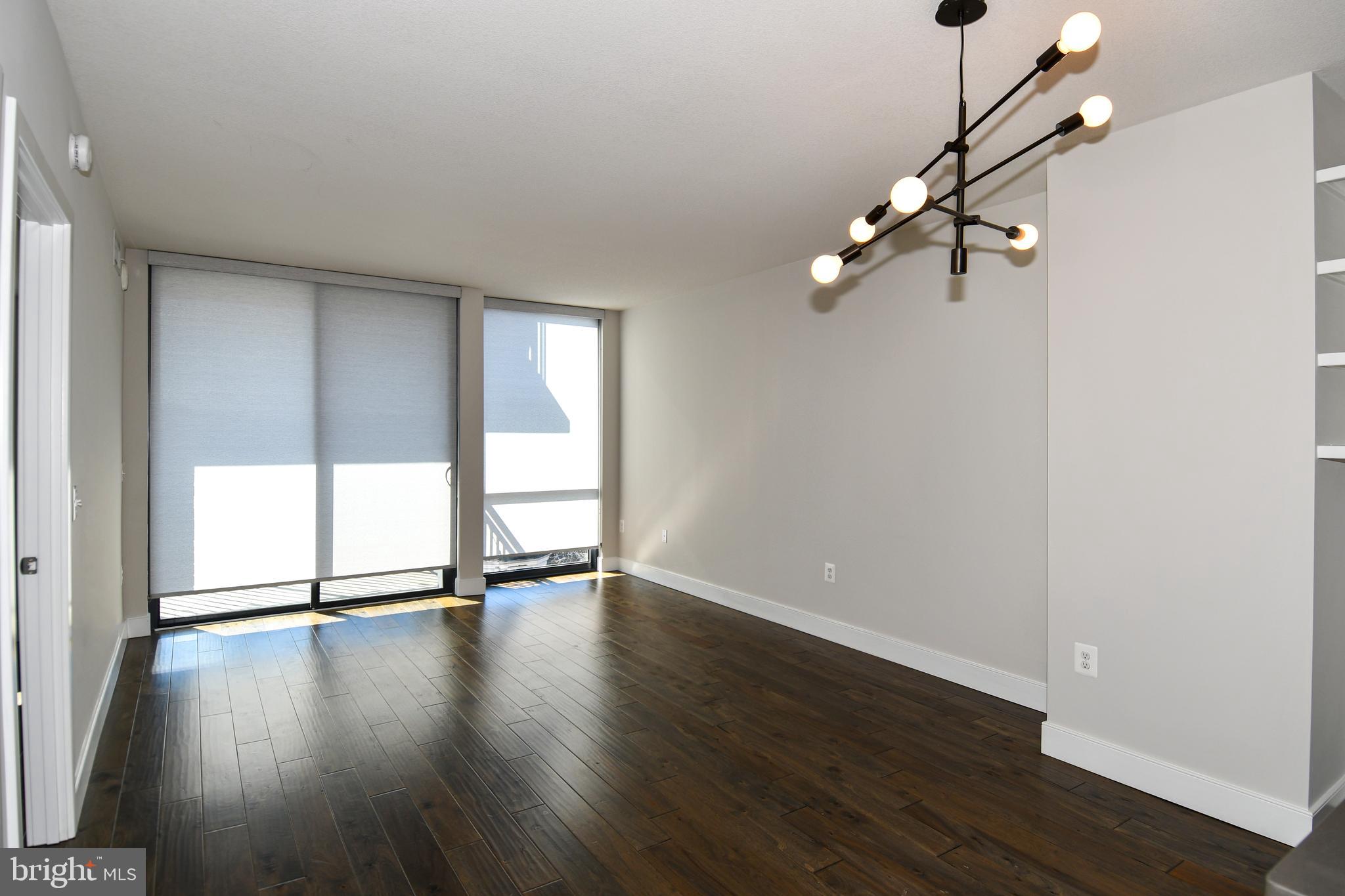 50 Florida Avenue Northeast, Unit 523 Washington, DC 20002 - Photo 6 of 38 a view of an empty room with a window and wooden floor