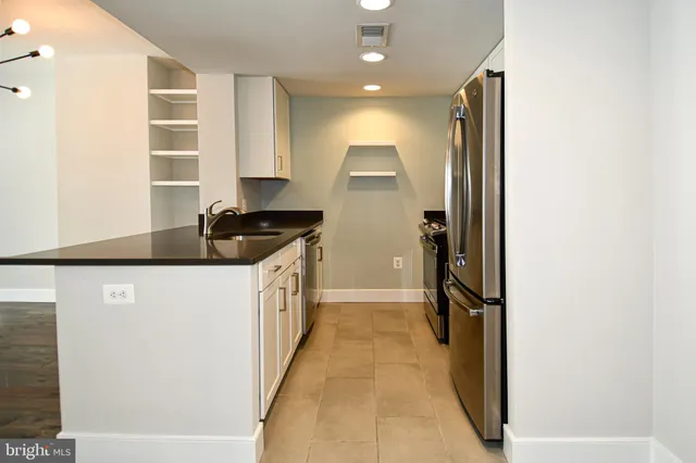 a kitchen with a refrigerator and a stove
