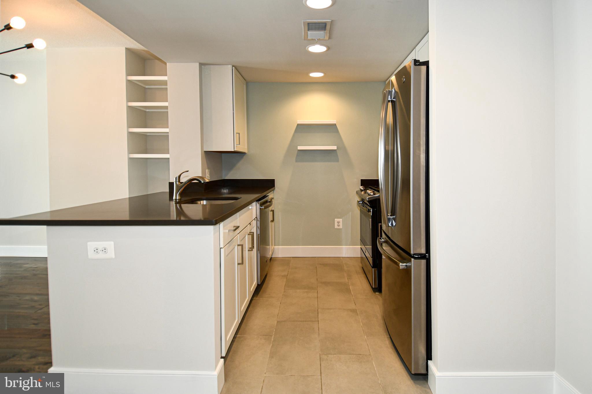 50 Florida Avenue Northeast, Unit 523 Washington, DC 20002 - Photo 10 of 38 a kitchen with a refrigerator and a stove