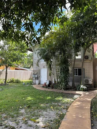 a backyard of a house with table and chairs