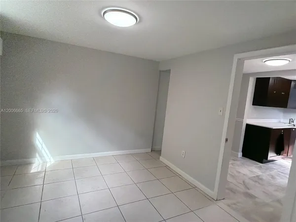 a view of an empty room with a fireplace