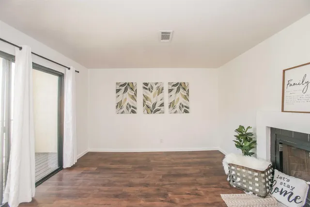 a kitchen with stainless steel appliances white cabinets and a stove a oven with wooden floor