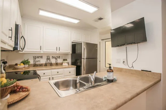 a kitchen with a sink a stove and a refrigerator