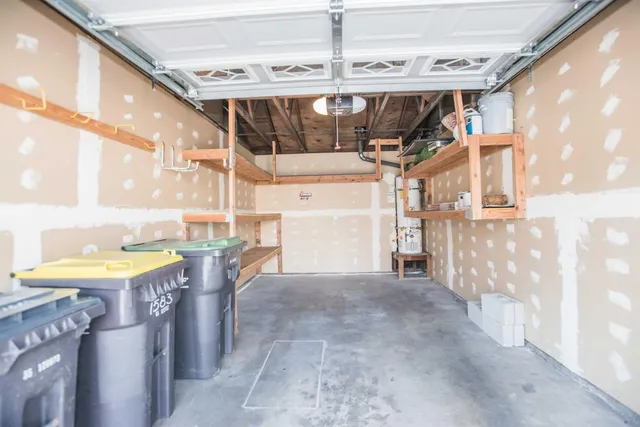 a patio with a table and chairs under an umbrella