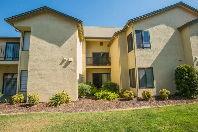 a view of a house with a yard and garden