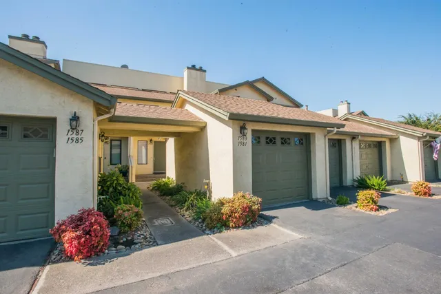 a view of a hallway with wooden floor and entryway