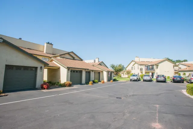 a view of a kitchen with wooden floor and a ceiling fan