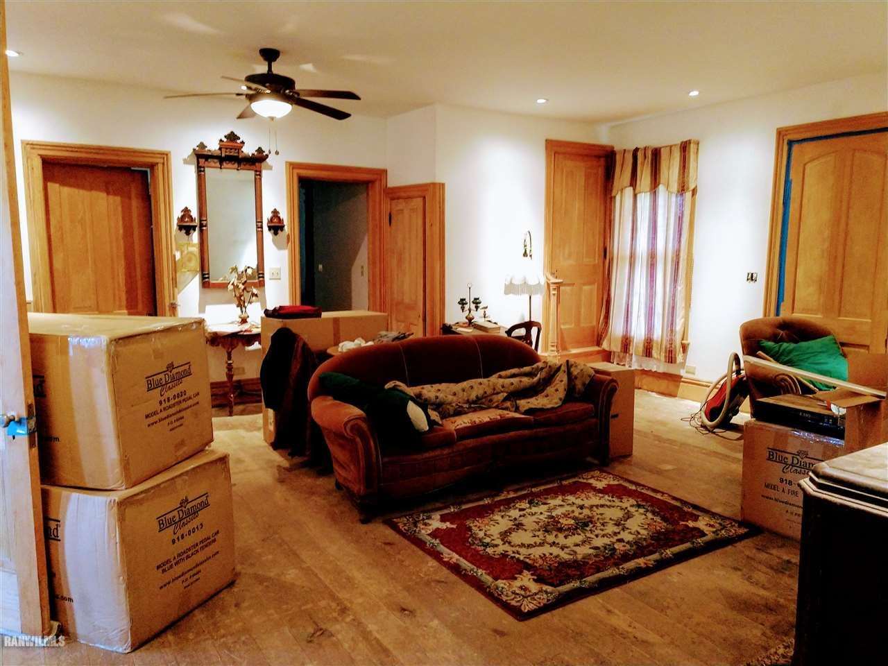 19129 Cyclone Ridge Road Mount Carroll, IL 61053 - Photo 12 of 33 a living room with furniture a large bed and a chandelier