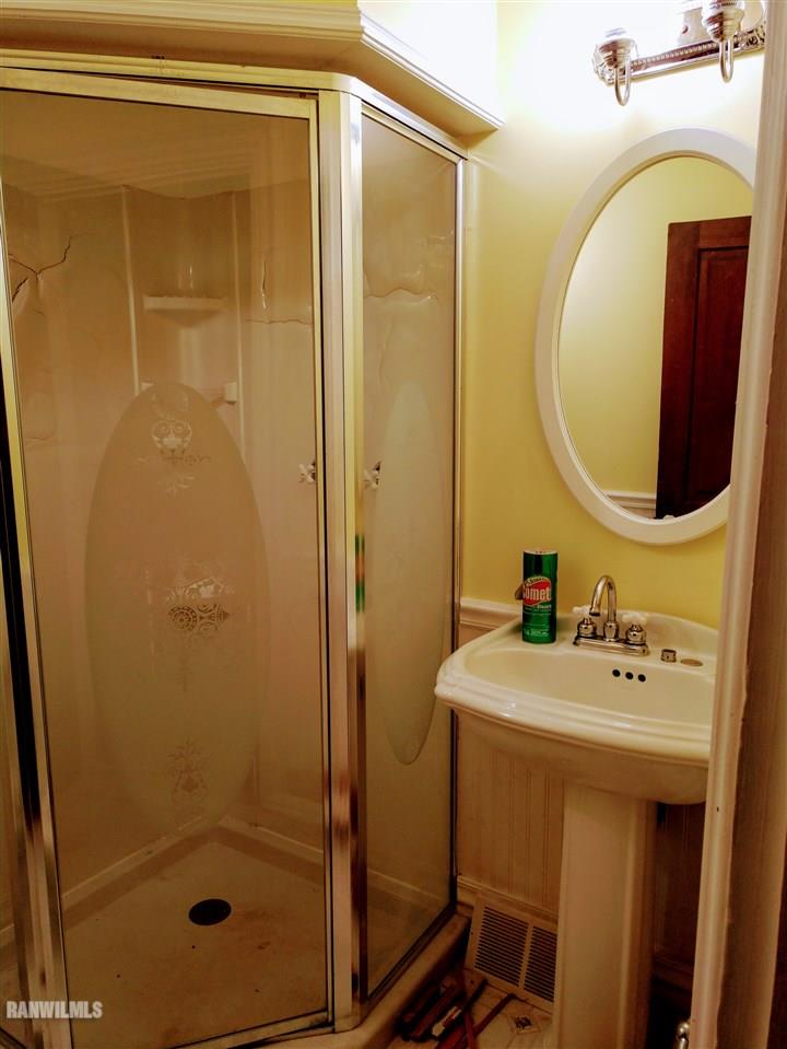 19129 Cyclone Ridge Road Mount Carroll, IL 61053 - Photo 22 of 33 a bathroom with a sink a mirror and shower