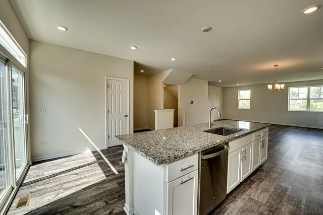 a kitchen with a stove and white cabinets