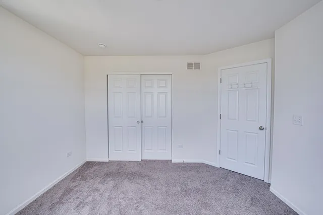 a view of an empty room and closet area