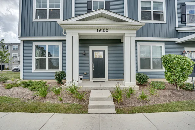 a front view of a house with garden