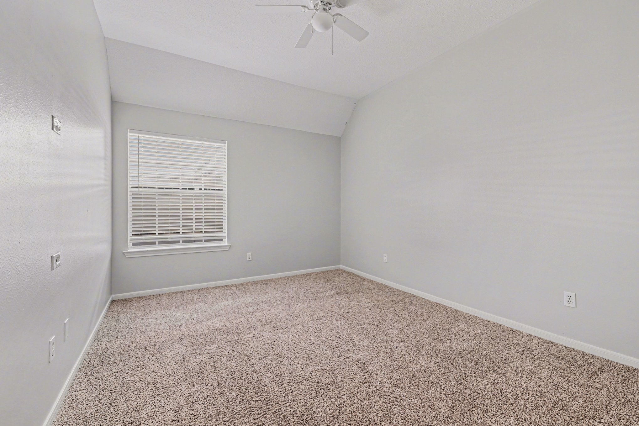 215 Bristol Bend Circle Spring, TX 77382 - Photo 18 of 25 an empty room with a ceiling fan and a window