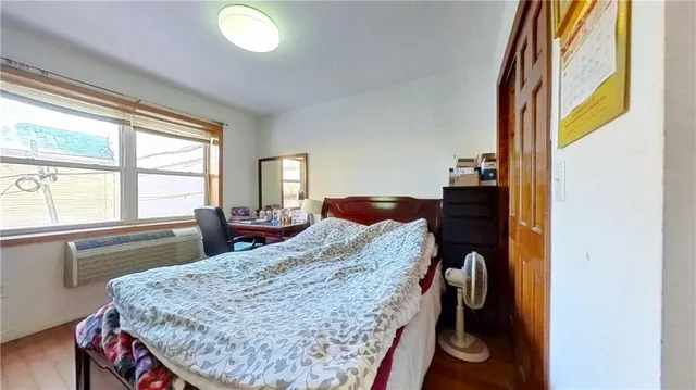 a bedroom with a bed dresser and a large mirror