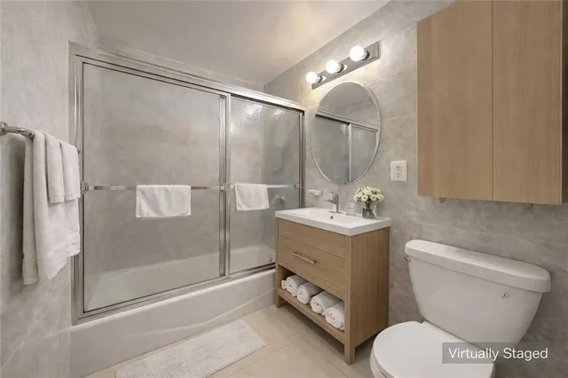 a bathroom with a toilet sink and shower