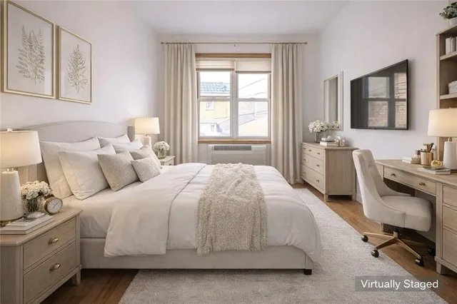 a bedroom with a bed a desk and mirror