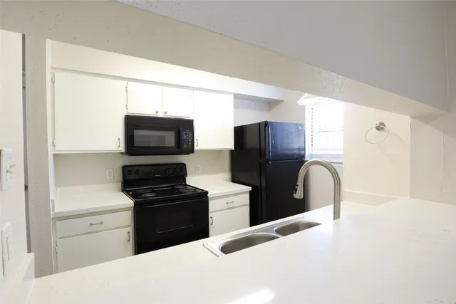a kitchen with a refrigerator stove and microwave
