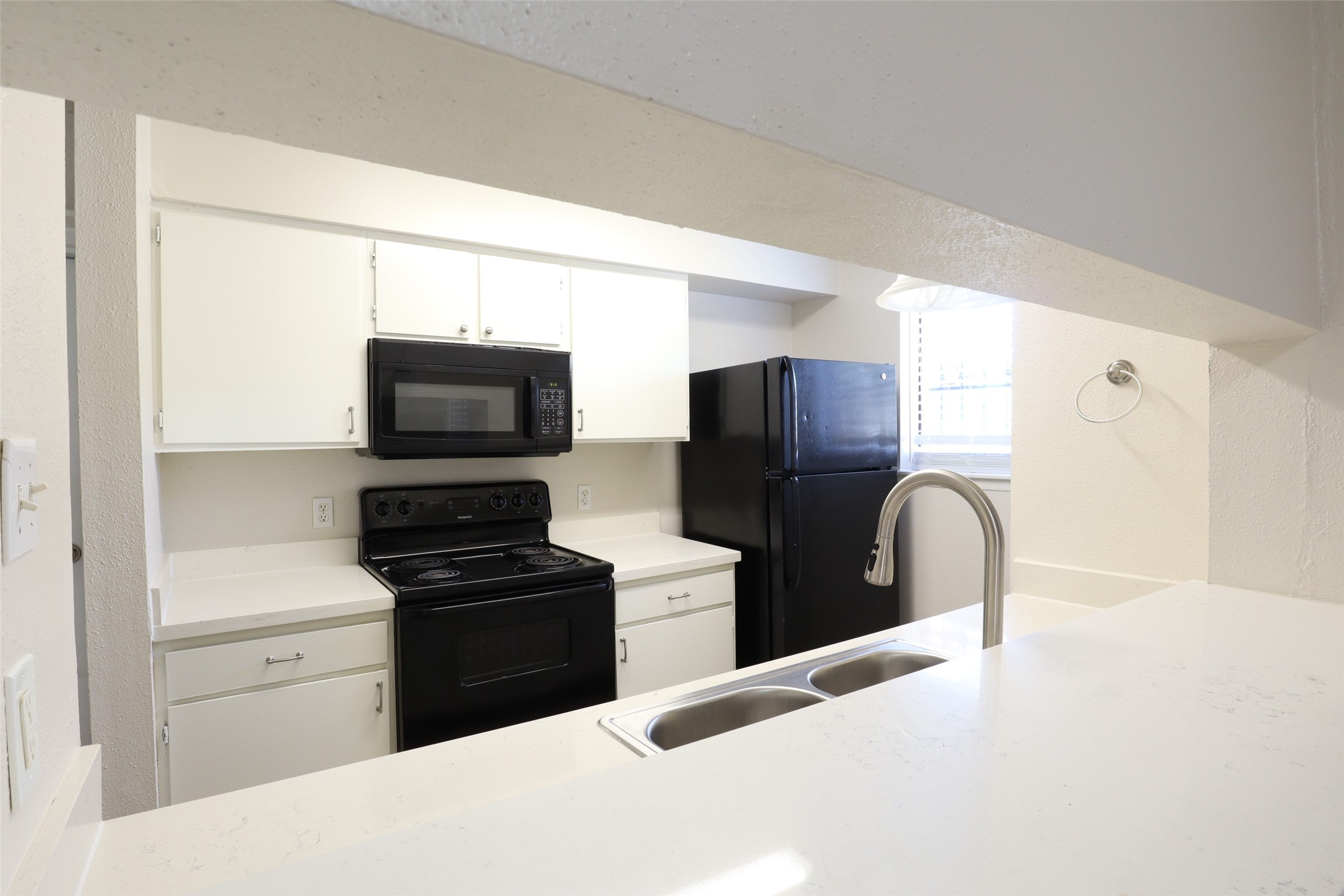 a kitchen with a refrigerator stove and microwave