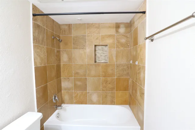 a bathroom with a shower and a bath tub