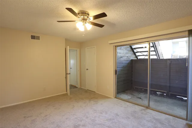 a view of an empty room with a fan
