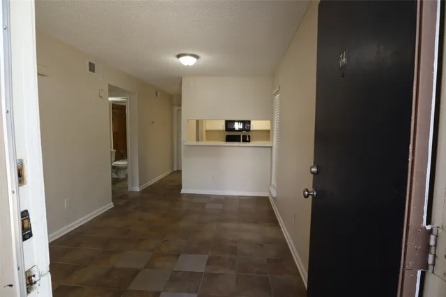 a view of a kitchen from the hallway