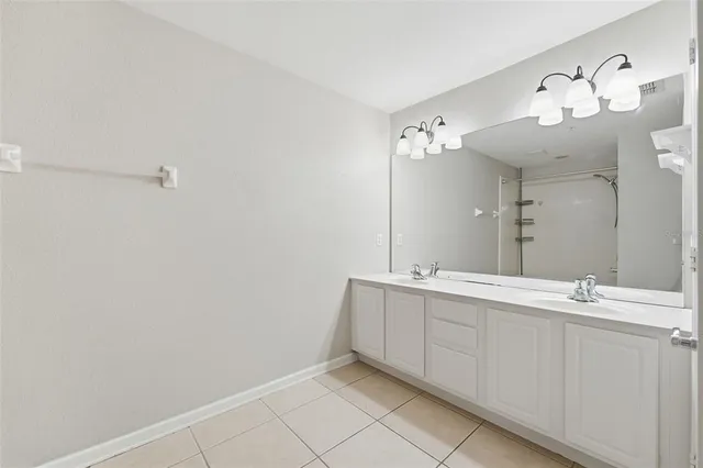 a bathroom with a double vanity sink and a mirror