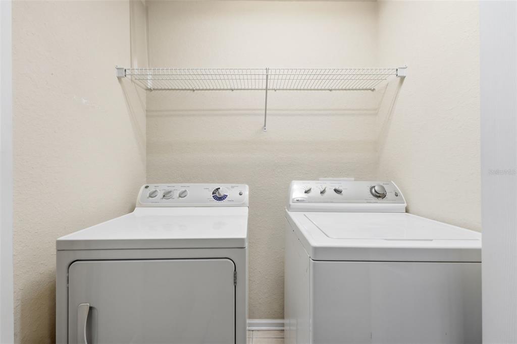 2838 Villafuerte Point, Unit 107 Orlando, FL 32835 - Photo 19 of 27 a utility room with dryer and washer
