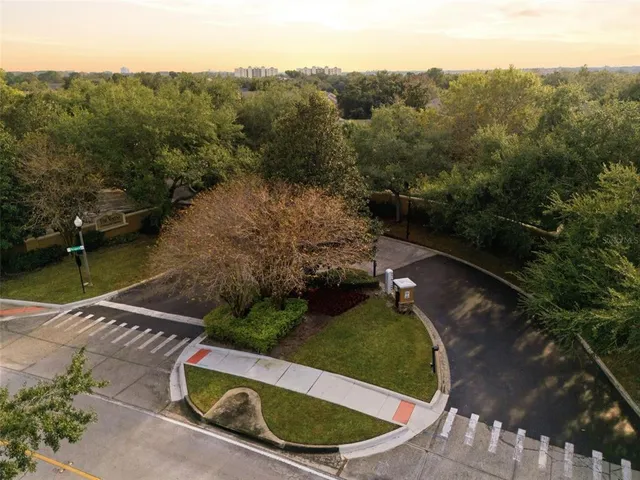 an aerial view of a house with a yard and lake view