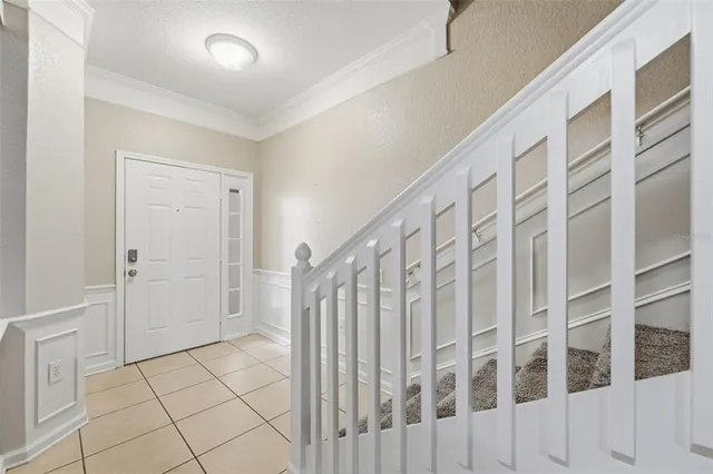 a view of staircase with white walls and white door