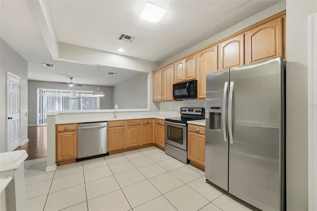 a kitchen with granite countertop appliances cabinets and furniture