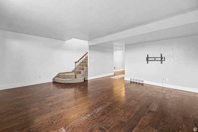 34 Benchmark Village Tooele, UT 84074 - Photo 7 of 35 Finished basement with stairway and dark wood-style floors