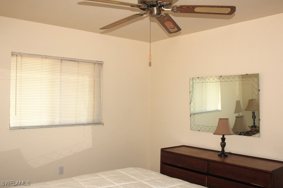 1221 Barrett Road, Unit 905 North Fort Myers, FL 33903 - Photo 14 of 22 a bedroom with a bed and a window