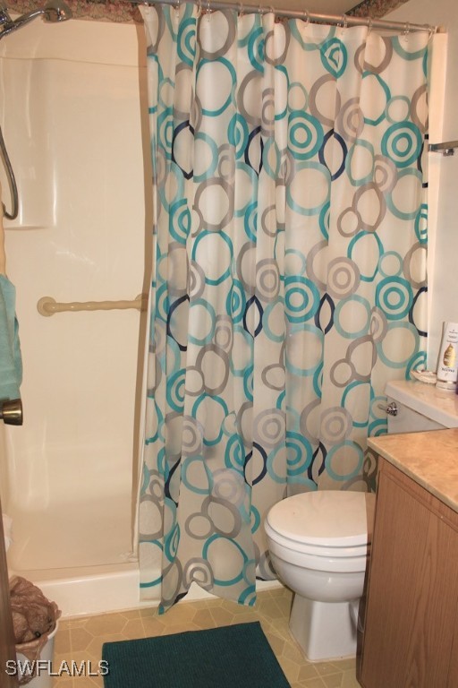 1221 Barrett Road, Unit 905 North Fort Myers, FL 33903 - Photo 16 of 22 a white toilet sitting next to a shower curtain