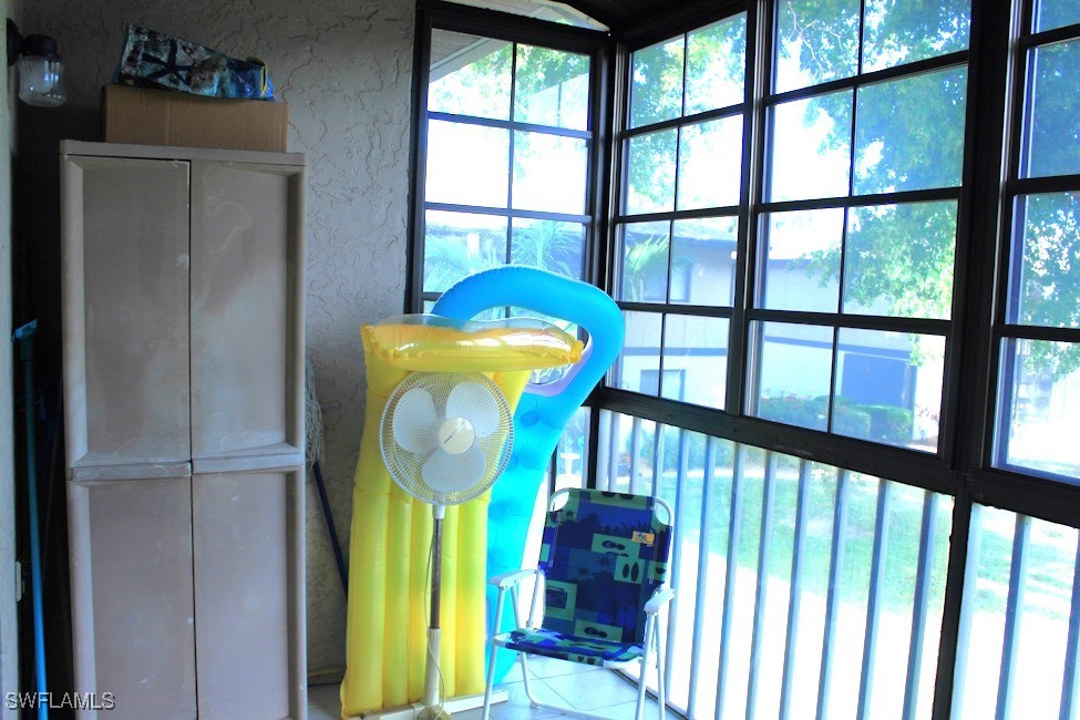 1221 Barrett Road, Unit 905 North Fort Myers, FL 33903 - Photo 19 of 22 a view of staircase with a fireplace and a window