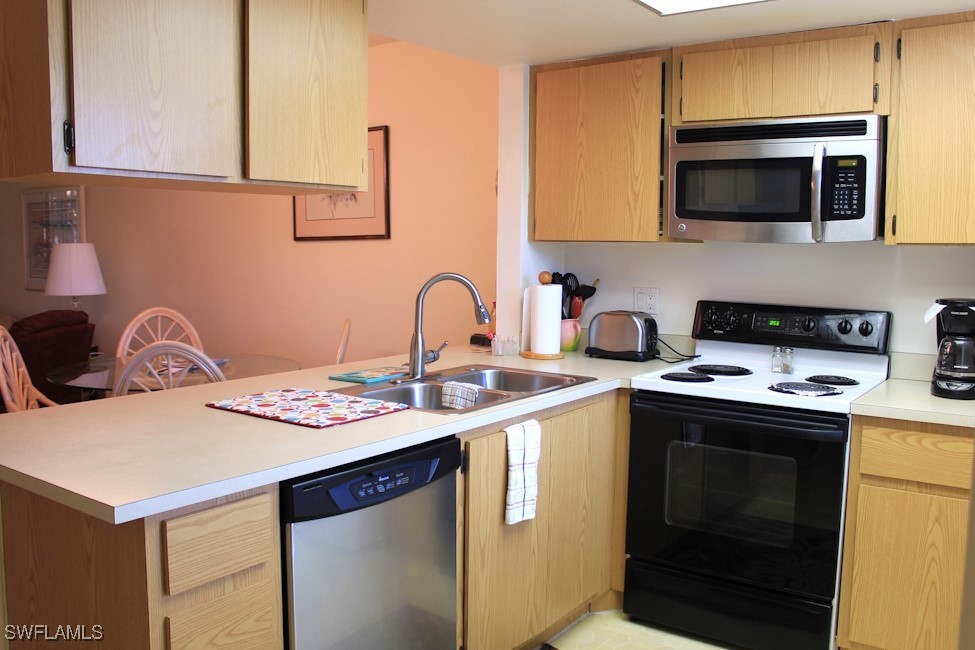 1221 Barrett Road, Unit 905 North Fort Myers, FL 33903 - Photo 6 of 22 a kitchen with a stove and a microwave
