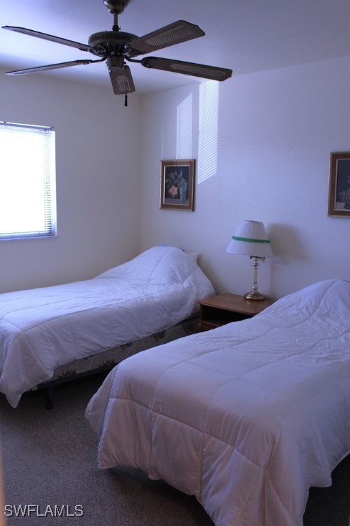 1221 Barrett Road, Unit 905 North Fort Myers, FL 33903 - Photo 10 of 22 a bedroom with three beds and a table