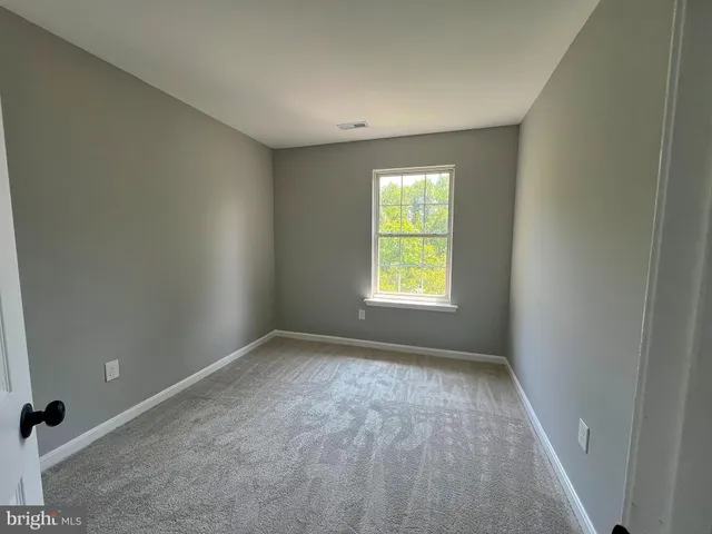 an empty room with a empty space and a window