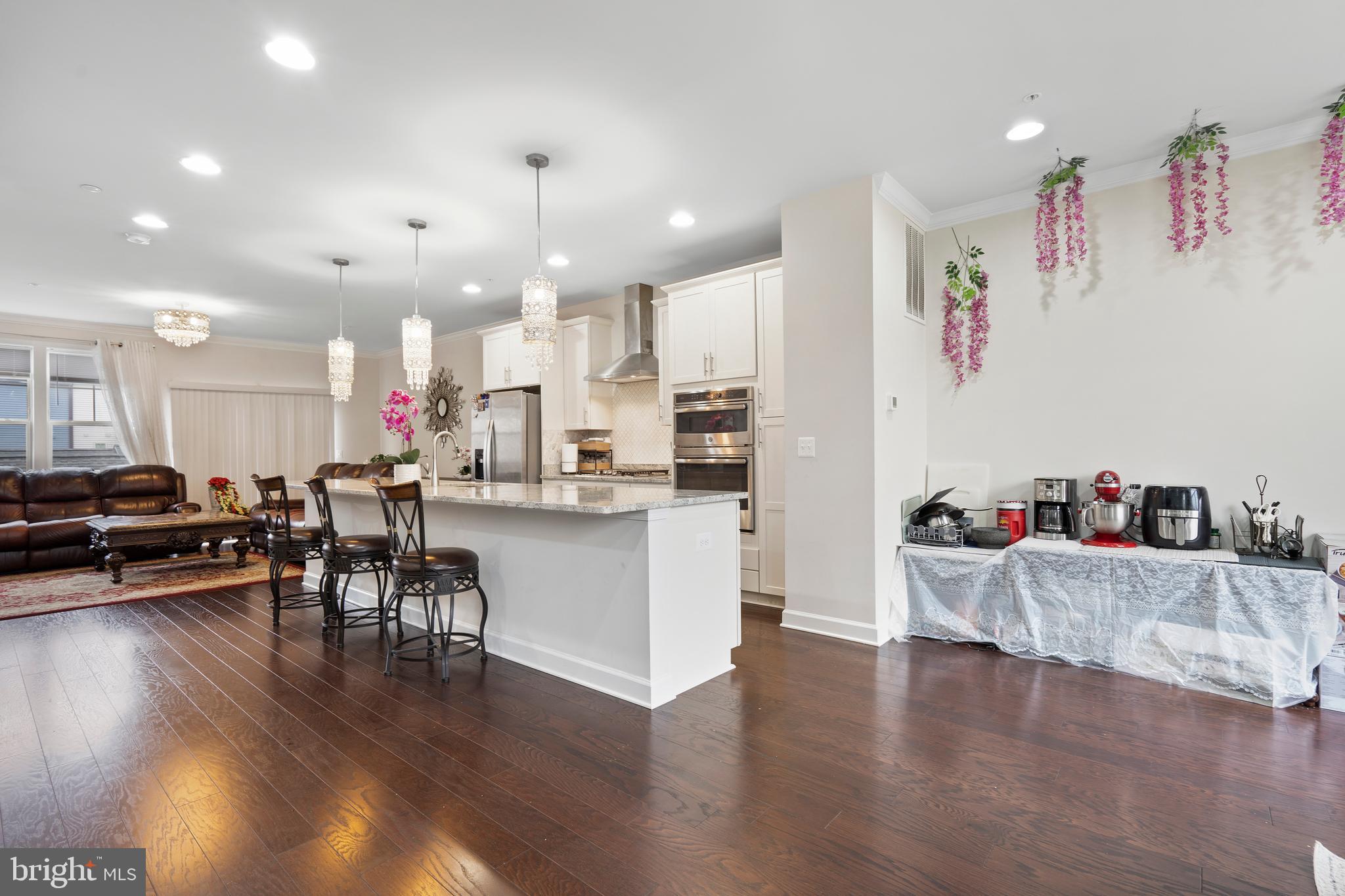 3516 Flatwoods Drive Frederick, MD 21704 - Photo 13 of 41 a living room with furniture and kitchen view with wooden floor