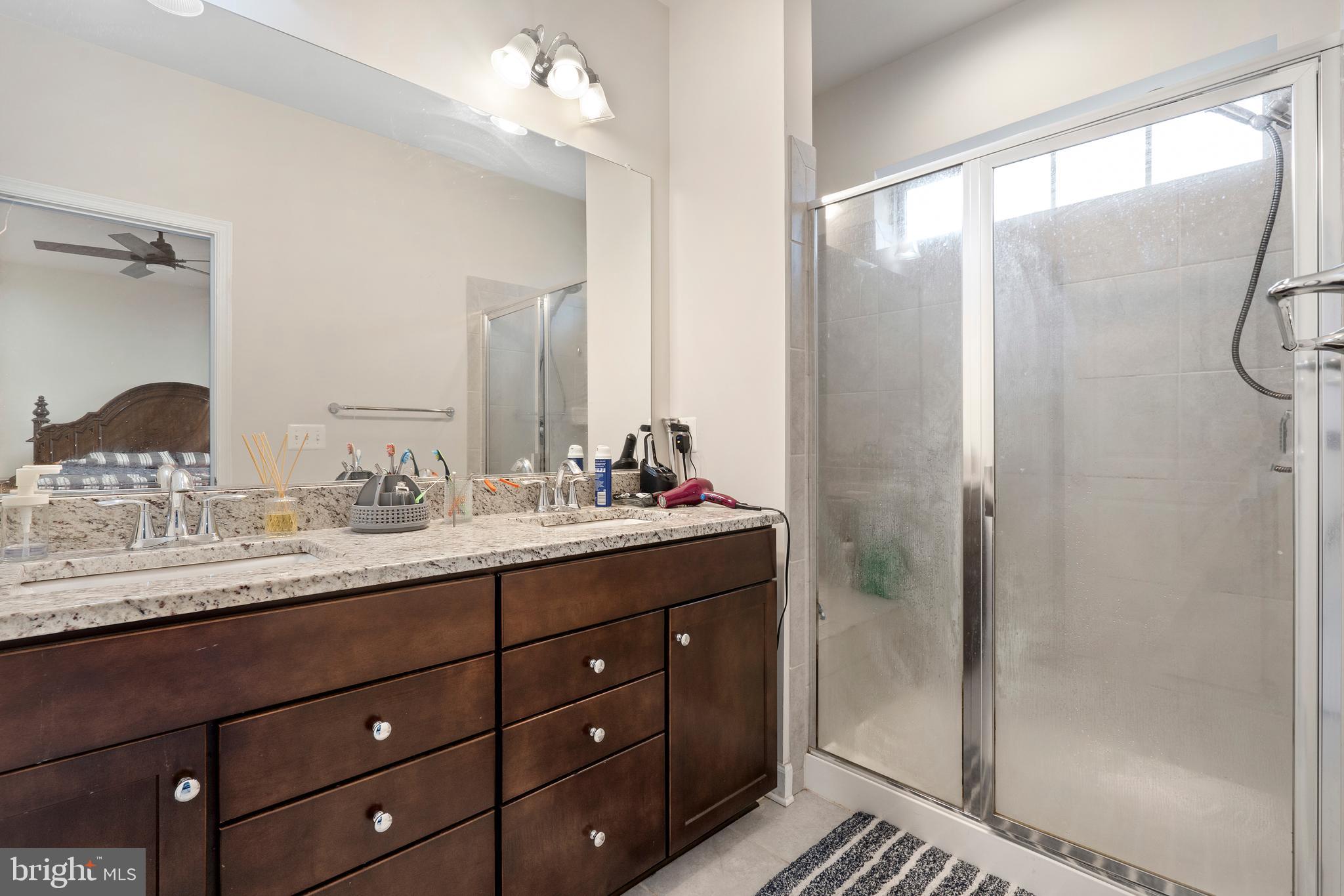 3516 Flatwoods Drive Frederick, MD 21704 - Photo 21 of 41 a bathroom with a granite countertop sink and a mirror