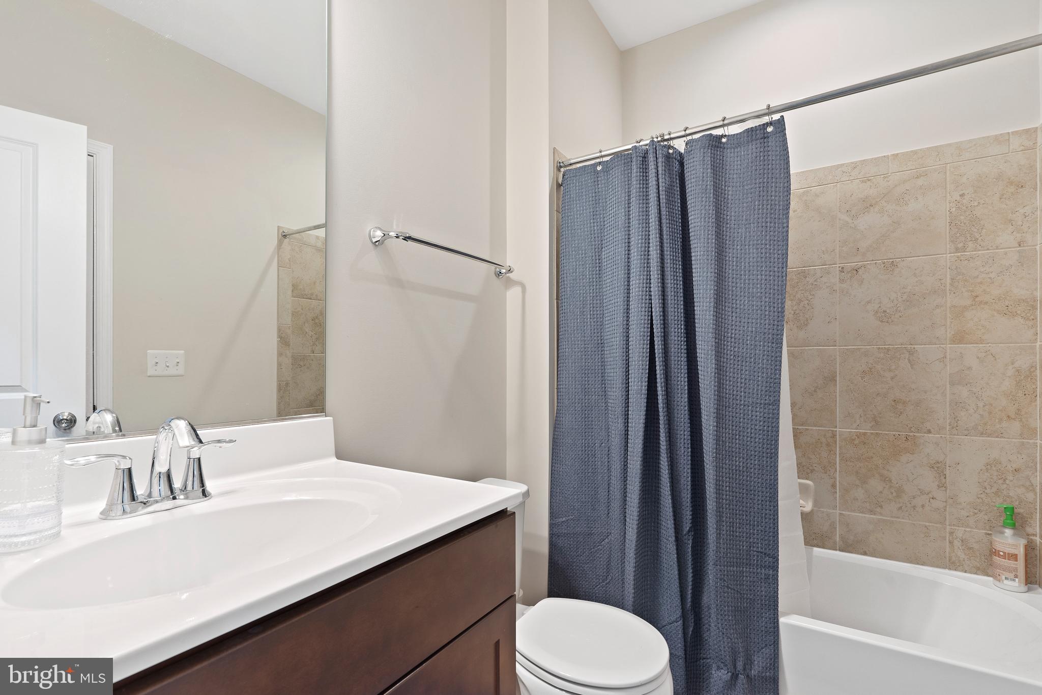 3516 Flatwoods Drive Frederick, MD 21704 - Photo 34 of 41 a bathroom with a sink a toilet a mirror and shower