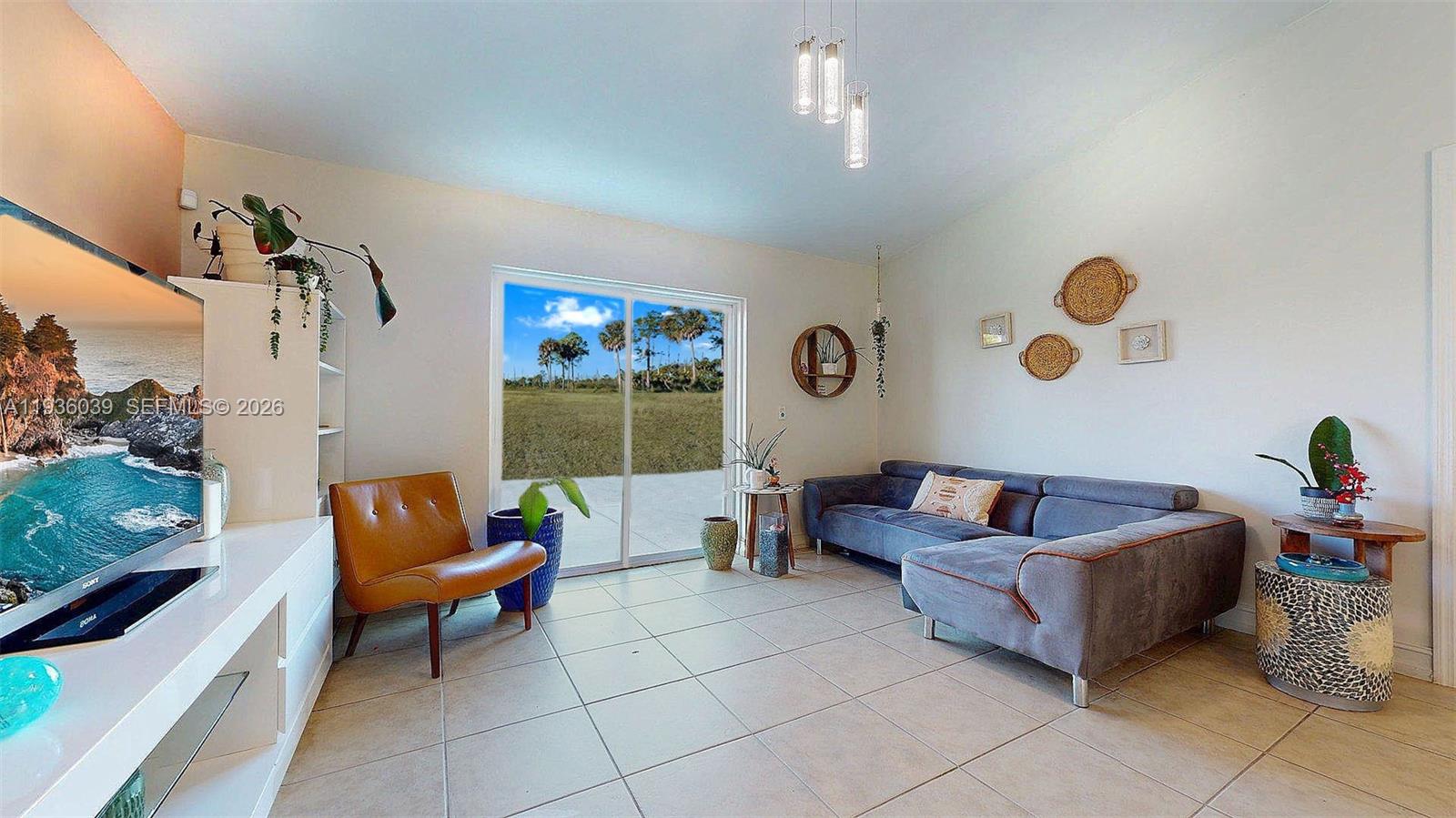 2625 40th Avenue Southeast Naples, FL 34117 - Photo 19 of 81 a living room with furniture and a flat screen tv
