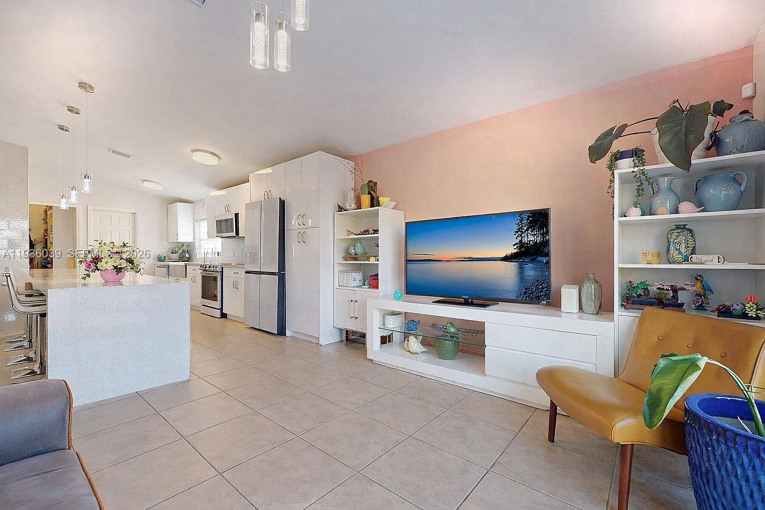 2625 40th Avenue Southeast Naples, FL 34117 - Photo 22 of 81 a living room with furniture and a flat screen tv