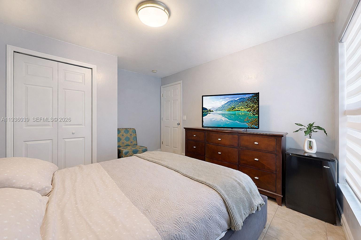 2625 40th Avenue Southeast Naples, FL 34117 - Photo 24 of 81 a bedroom with a bed and a flat screen tv