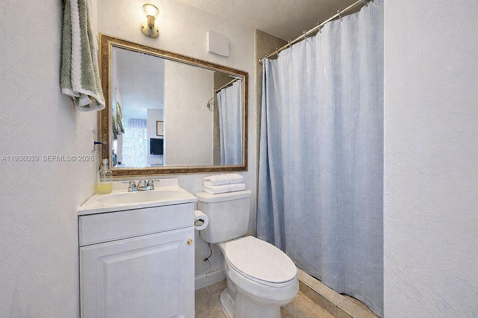 2625 40th Avenue Southeast Naples, FL 34117 - Photo 35 of 81 a bathroom with a toilet a sink and a mirror