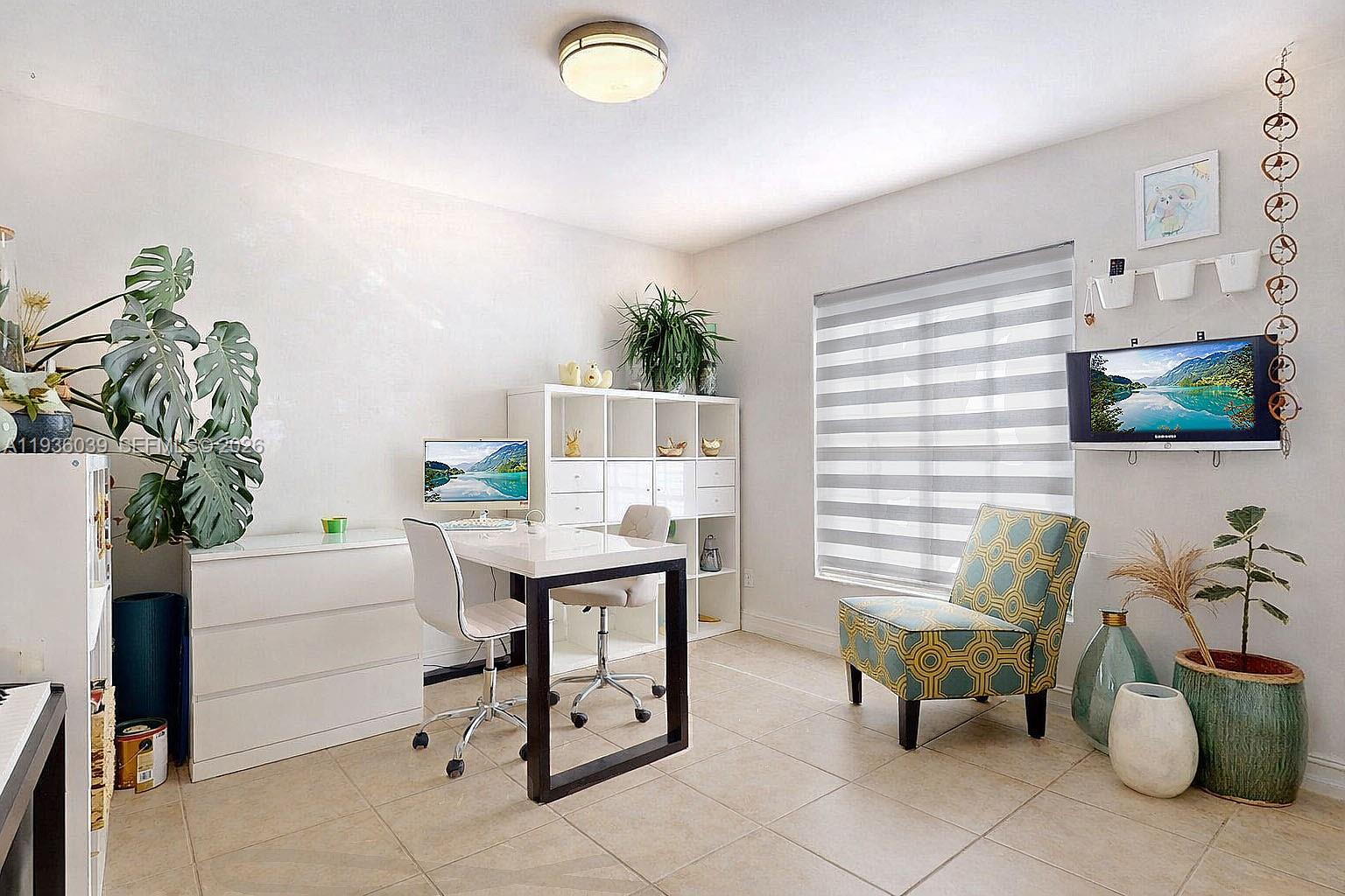 2625 40th Avenue Southeast Naples, FL 34117 - Photo 36 of 81 a living room with furniture and a potted plant