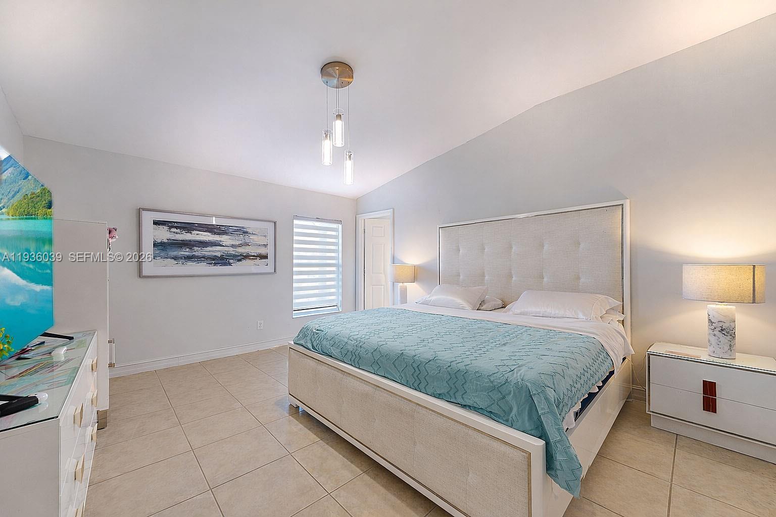 2625 40th Avenue Southeast Naples, FL 34117 - Photo 38 of 81 a spacious bedroom with a bed and a flat screen tv
