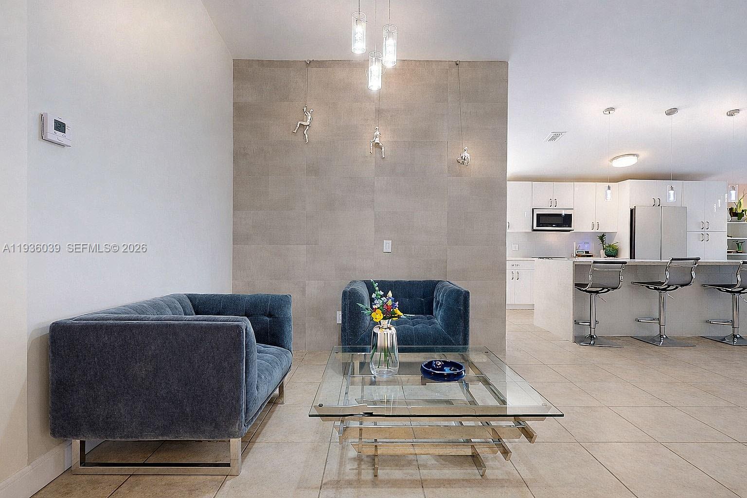 2625 40th Avenue Southeast Naples, FL 34117 - Photo 4 of 81 a living room with furniture and a table