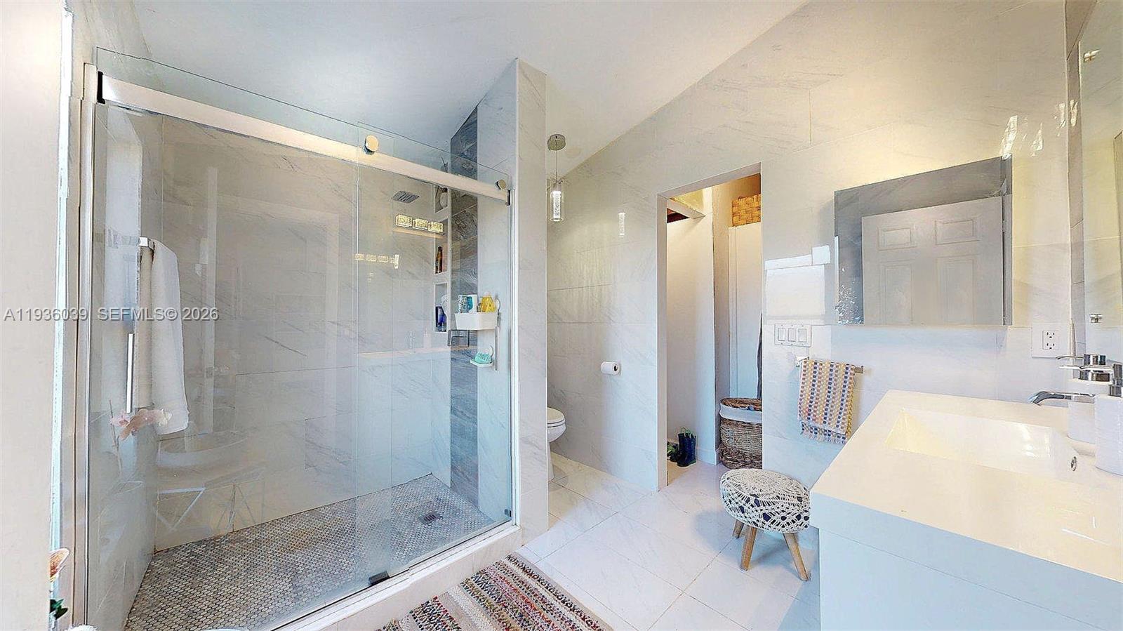 2625 40th Avenue Southeast Naples, FL 34117 - Photo 42 of 81 a bathroom with a sink and shower