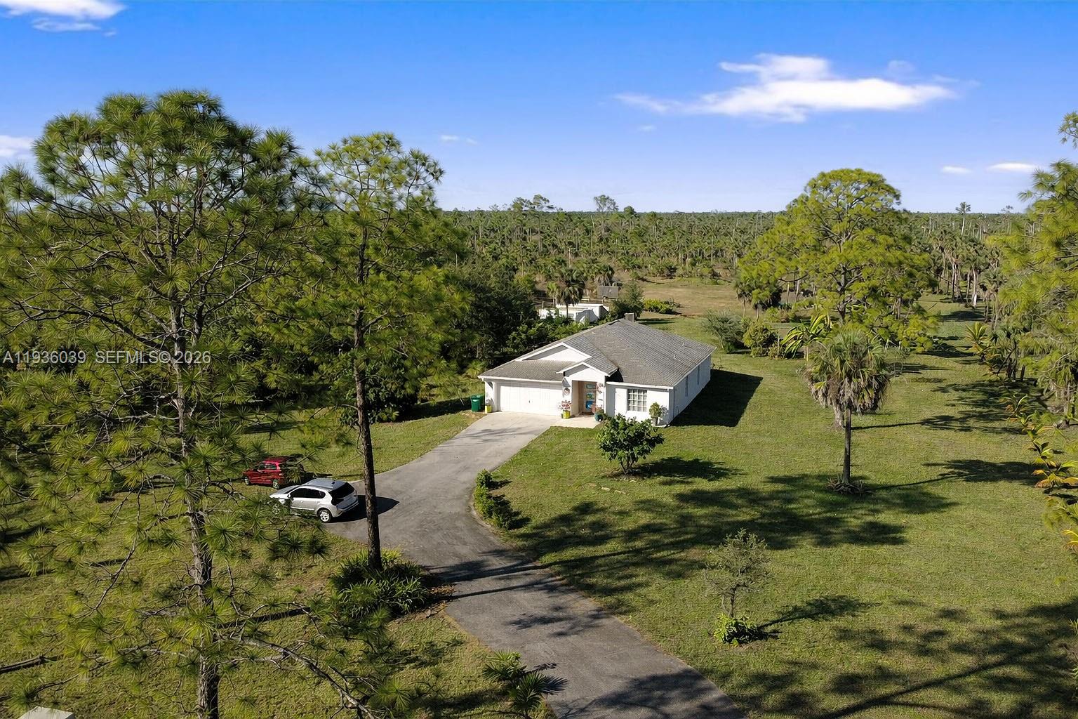 2625 40th Avenue Southeast Naples, FL 34117 - Photo 47 of 81 a view of a houses with a yard